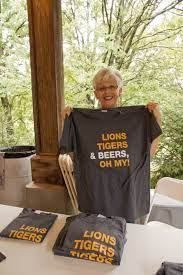 Carlin A Bpz Volunteer Holds Up A 2012 Zoo Brew Shirt They Were A Huge Hit Lions Tigers And Beers Oh My Brew Shirts Beer Volunteer