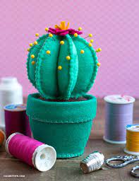 Use a pin, awl, or other sharp implement to score inside the fill the bottom inch or so of the terracotta pot with small decorative river rocks to weight the pin cushion. How To Make A Felt Cactus Pincushion Lia Griffith