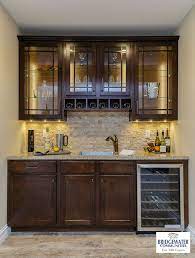 Maybe you would like to learn more about one of these? Bridgewater S Custom Bar In The Finished Lower Level Includes Glass Front Cabinets With Led Cabinet And Under Basement Bar Designs Basement Bar Bars For Home