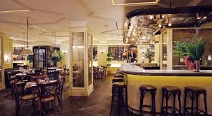 Tables are surrounded by generous banquettes of soft brown leather, recently laid tiles look to have been there forever, and delicate stemware straddle the classic and contemporary. New York City Midtown Restaurant New York Dinner Cafe Interior Design Restaurant New York Bar Interior Design