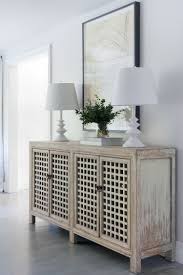 Entryway Cabinet With Perforated Panels Matching Pair Of Table Lamps Large Artwork In The Entry Minimalist Home Decor Home Decor Minimalist Home Interior