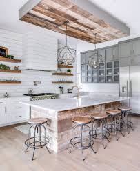 Black worktop, range hood, and refrigerator meet the white units in stunning contrast. 75 Beautiful Farmhouse Kitchen With Wood Backsplash Pictures Ideas July 2021 Houzz