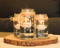 30 Rustic Mason Jar Centerpiece With Floating Candles On Wood Slices Advantage Destinati Floating Candles Mason Jars Mason Jar Centerpieces Rustic Mason Jars