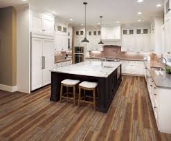 Dark cabinetry and mood lighting combine to create a wonderful mood in this kitchen. The Best Way To Clean Your Floor Wood Tile Grout Stone Laminate