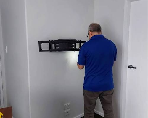 Erith specialist routing cables behind mounted TV