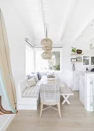 Beach Style Eat In Kitchen Features A Whitewash Oak Plank Dining Table Accented With A Ca In 2020 Coastal Dining Room Dining Table With Bench Beach Style Dining Tables