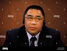 Former Macau Culture Minister Fernando Chui wears a headphone before a  meeting with law association Tuesday, June 23, 2009. Chui is the only  prominent candidate so far for Macau's leader election on