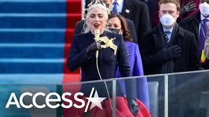 Elizabeth banks as effie trinket in hunger games and lady gaga at the inauguration of president joe biden.lionsgate ; Lady Gaga S Inauguration Dress Had A Secret Meaning Youtube