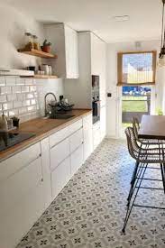 White marble cabinets, a magenta runner, blooming florals, and ladylike details give this galley kitchen gorgeous personality, while strategically placed mirrors make the small space feel larger. Right Now Galley Kitchens Are Prevalent In An Apartment Or Small Home Galley Kitchen R Galley Kitchen Design Kitchen Design Small Small Galley Kitchen Designs
