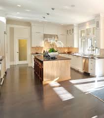 Kitchen opens up into living space and includes large central island with sink. How To Style Dark Wood Floors Harman Hardwood Floor