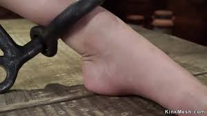 Brunette slave standing with ankles and wrists and neck in metal stocks  then sitting in other metal restraint and getting vibrated - XNXX.COM