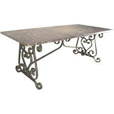 Crafted from wrought iron in an antique silver finish, it features a base with four slender, curving legs and arched accents for a vintage french country look. Wrought Iron Art Nouveau Garden Table Travertine Marble Top France Circa 1900 Tiled Coffee Table Wrought Iron Dining Table Marble Top Dining Table