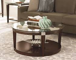 Classic coffee tables are usually rectangular in shape, but what about an accent piece that has a let's have a look at some beautiful ideas, designs and photos of round coffee tables that are not a round, black shining top with a metal base this slender piece will fit inside a variety of living rooms. Various Ideas Of The Round Glass Coffee Table For Your Beautiful And Comfy Living Room Area Artmakehome