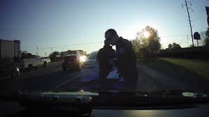 Watch: Police Officer Stuck in Suspect's Car During High-Speed Chase