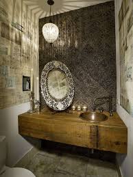 A moroccan silhouette bathroom nook boasts a honed marble sink vanity fitted with a square vessel sink mounted under an antique brass vintage style faucet mounted to blue and gray mosaic wall tiles. Modern Moroccan Bathroom Design
