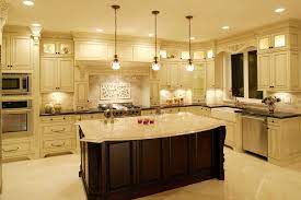 The beige cream granite counter top and the ceramic tiles on the backsplash adds a subtle contrast to the white cabinets. Modern And Traditional Kitchen Island Ideas You Should See Kitchen Lighting Design Antique White Kitchen Home Lighting Design