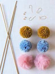 Take the two long pieces of yarn and tie your pom pom to your earring making sure that your knot is snug against the pom pom and the earring. Diy Pom Pom Earrings Honestly Wtf