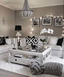 A white cushioned sectional wraps two of the walls, hugging an arrow foot coffee table facing the fireplace. Cozy Grey And White Living Room Novocom Top