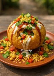 Raj Kachori Street Food Chaat with large puri filled with sprouts, potatoes, yogurt and chutneys