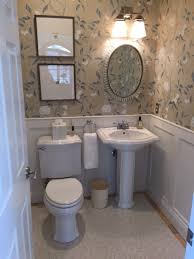 Old materials, such as a weathered wooden vanity table and thrift shop mirror, blend. Traditional Powder Room Kt Highland