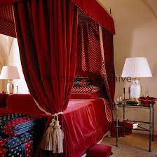 Elegant canopies can do wonders get jealous with the full draped canopy beds we are about to show you. Sumptous Red Velvet Drapes With A Red And Gold Lining Hang Around This Four Poster Bed Red Velvet Curtains Velvet Drapes Rustic Curtains