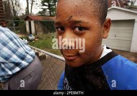Isaiah Greene poses for a picture while taking a break from power washing  his grandfather's driveway in the flood-damaged Island neighborhood of  Trenton , N.J., Thursday, April 7, 2005. Residents of the