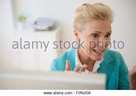 Mature blonde works legs in the gym. Mature Blonde Active Female In Leggins Sneakers And Windbreaker Doing Exercise For Legs On Background Of Modern Building Stock Photo Alamy