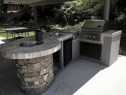 Use additional frame kits to create a custom outdoor kitchen with a personal touch Custom Outdoor Kitchen With Rock Extreme Backyard Designs