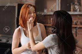 Joyful young couple lying on bed inside home cuddling and being affectionate in the morning. Enjoy The Moment Portrait Of A Lesbian Girl Holding Pink Cookie Stock Photo Picture And Royalty Free Image Image 68515672