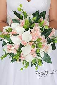 Get creative and mix white fake flowers with cream artificial flowers, add a dash of artificial greenery, and sprinkle in white roses or white hydrangeas for an everlasting and elegant look. Light Pink Brides Bouquet With Calla Lilies Cherry Blossoms And Mixed Greenery Silver Dollar Flower Bouquet Wedding Green Wedding Flowers Lily Bridal Bouquet