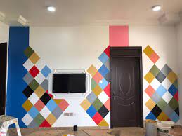 Layered rugs soften the space, while yellow living room accessories, including fresh flowers, a lampshade, and throw pillows, incorporate the sunny color scheme throughout. New Design Painting On Walls Shops Bedrooms And Living Room S Home Facebook