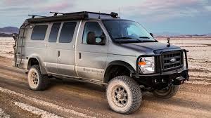 Grey Sportsmobile 4x4 Classic Conversion Covered In Mud On A Dirt Road Sportsmobile Sportsmobile 4x4 Ford Van