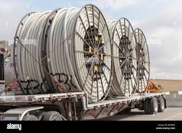 An American Peterbilt 379 semi truck hauling reels of HDPE ...