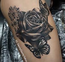 Blue butterfly and rose bud tattoo on leg. Realistic Black And Grey Rose Tattoo On A Thigh With Butterfly This Was The Start Of An On Rose Tattoos For Women Rose And Butterfly Tattoo Black Rose Tattoos