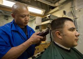 Ship's Serviceman 3rd Class Bryan Apostol, left, gives