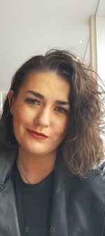 A funeral service is being held in a church for a woman who has just passed  away. At the end of the service the pallbearers are carrying the casket  out, when they