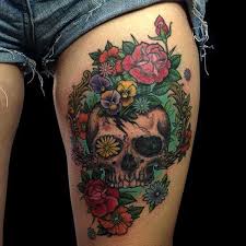 Flowers play a very important in each and every occasion of a human being. Colorful Flower Skull Tattoo On Left Upper Thigh