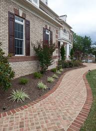 This Beautiful Brick Home Features A Rowlock And Soldier Course Water Table Jack Arches With Keystones And Brick Quoi Outdoor Landscaping House Exterior Patio