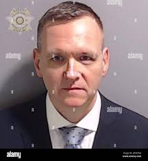 Undated handout photo issued by Fulton County Sheriff's Office of the  booking photo of Michael Roman after he surrendered and was booked at the  Fulton County Jail in Atlanta. Former US President