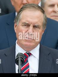 New England Patriots head coach Bill Belichick talks with referee Tra Blake  (3) and side judge Don Willard (58) prior to taking