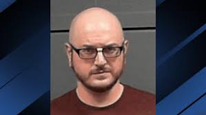 Man charged after photos, video found