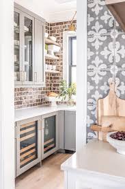 Darker red cabinets add warmth to this contemporary kitchen by douglas design studio of dering hall. Gray Pantry Cabinets With Red Brick Backsplash Cottage Kitchen