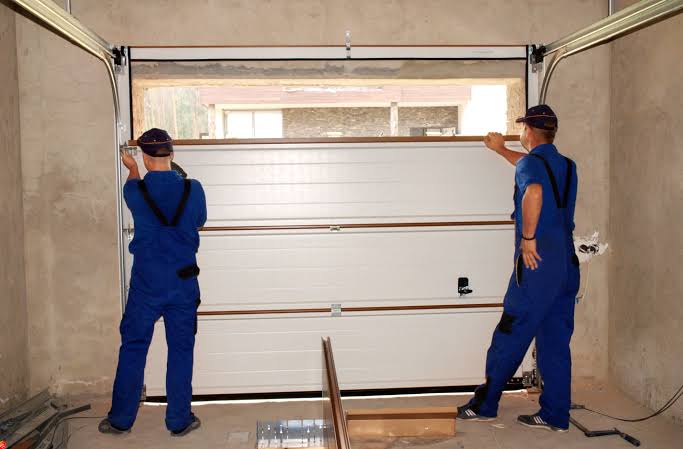 Ascendra technician inspecting a garage door spring system on a Las Vegas home