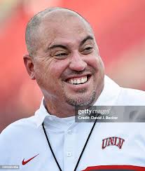 Quarterback Johnny Stanton of the UNLV Rebels hits tight end Tim Holt...  News Photo
