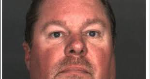 High school principal is arrested and charged with committing lewd acts  with a boy