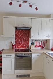 Cream Shaker Country Style Kitchen Red Metro Tile Herringbone Feature Splash Back Ours Kitchen Cabinets Decor Kitchen Cabinet Design Red Kitchen Accessories