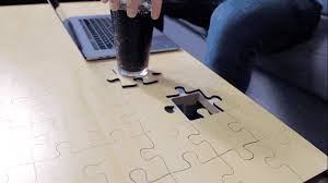Before you can enjoy this modern looking coffee table, you must first assemble the jigsaw puzzle surface. The Jigsaw Puzzle Coffee Table By Unnecessary Inventions Kickstarter