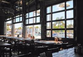 Well Not Really For The Home Cool How Garage Doors Are Used For The Union Kitchen Tap Restaur Garage Door Windows Commercial Garage Doors Glass Garage Door