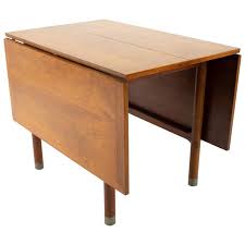 The leaves lift easily and the slide supports function perfectly. American Of Martinsville Mid Century Drop Leaf Dining Table With Metal Accents For Sale At 1stdibs