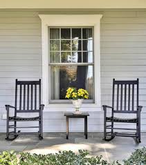 Front Porch With Black Rocking Chairs And Table With Yellow Flowers White Pot Gray Siding Grey Siding Porch Colors Stone Porches